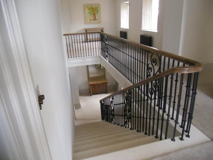 32. Portland stone staircase with metal balustrade and oak handrail – Cotswolds