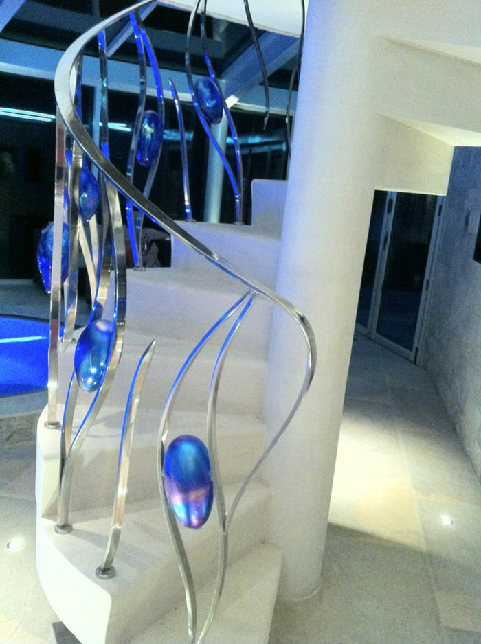 spiral moleanos stone staircase with chrome and blue glass